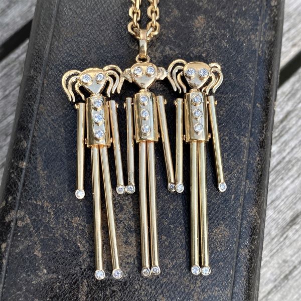 Vintage Diamond Peg Children Pendant sold by Doyle and Doyle an antique and vintage jewelry boutique