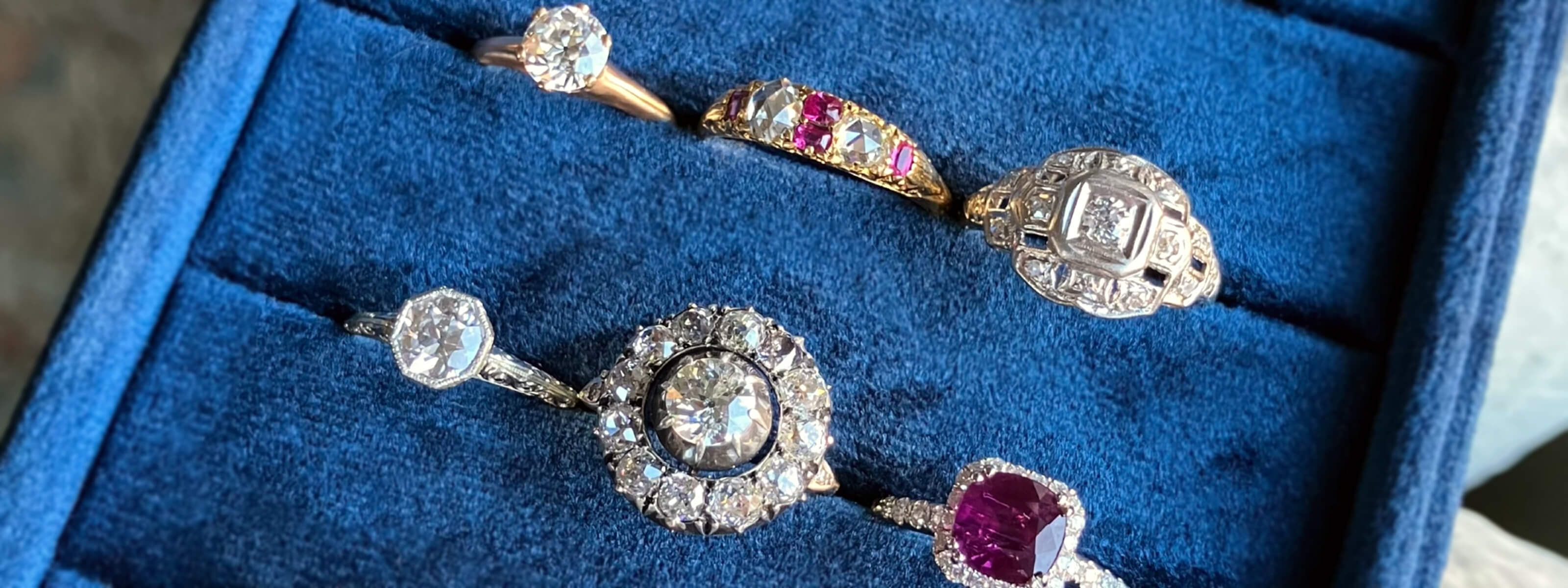 Vintage engagement rings displayed in a blue box
