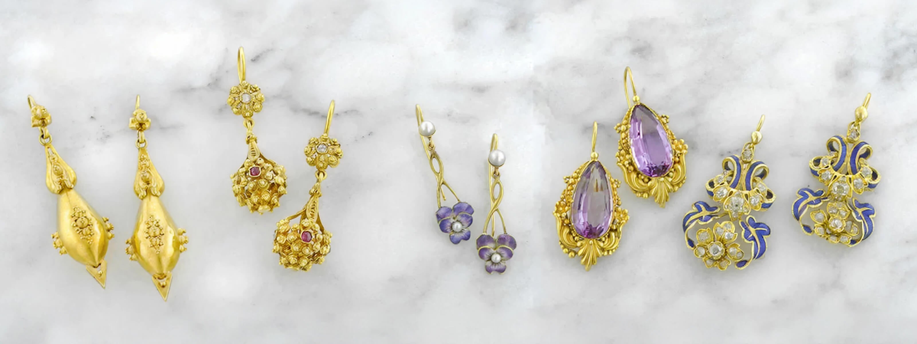 Vintage and Antique earrings on a marble surface