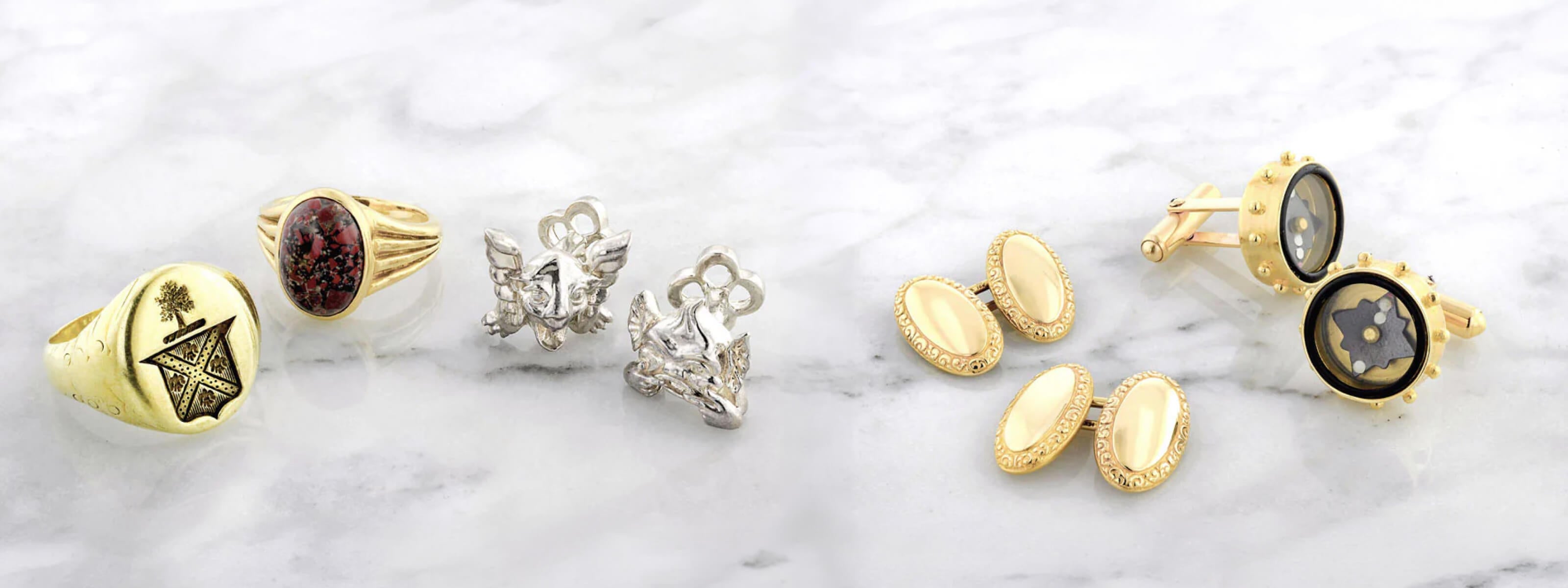 Men's rings and cuff links on a marble surface