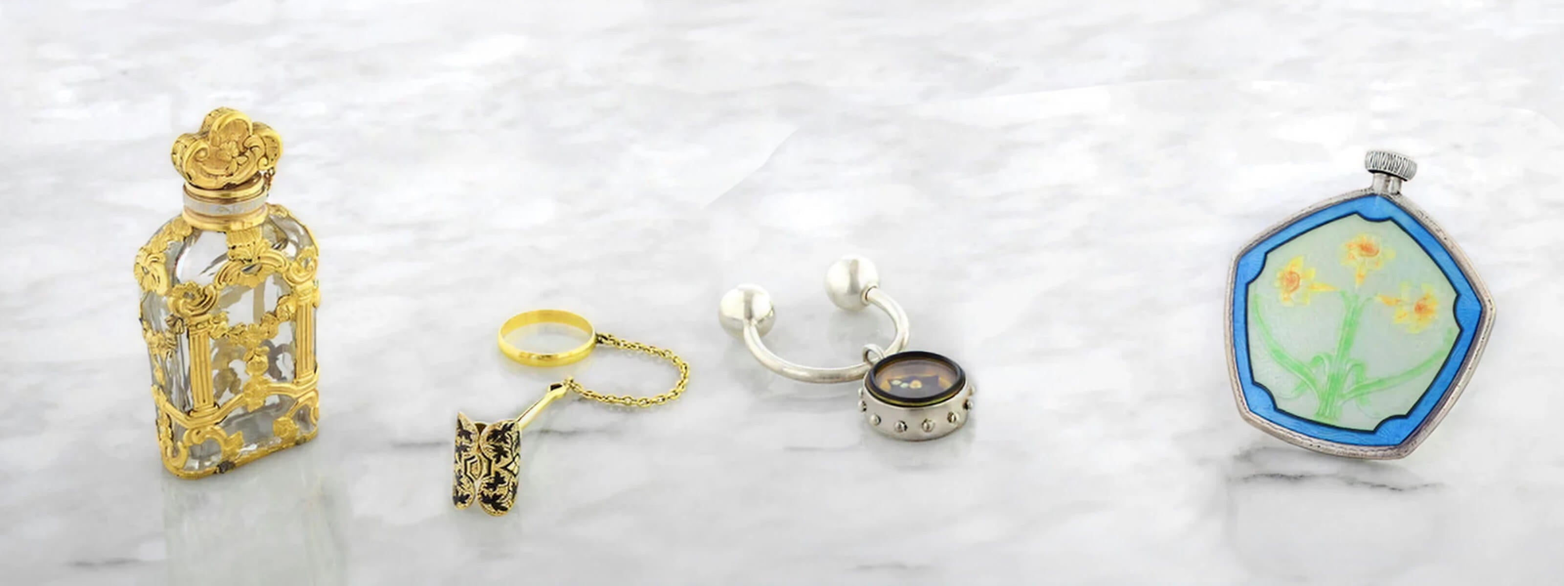 a variety of vintage and antique accessories on a marble surface
