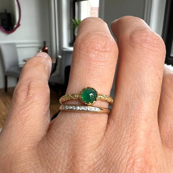 Cabochon emerald ring stacked with a vintage diamond band, both from Doyle & Doyle jewelry
