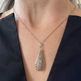 Vintage Filigree Diamond Pendant/ Brooch sold by Doyle and Doyle an antique and vintage jewelry boutique