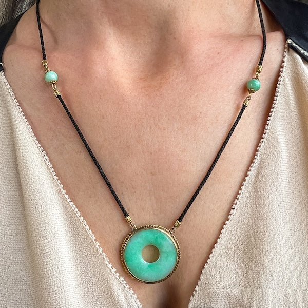Vintage Jade Pi Pendant on black cord, sold by Doyle & Doyle an antique and vintage jewelry boutique