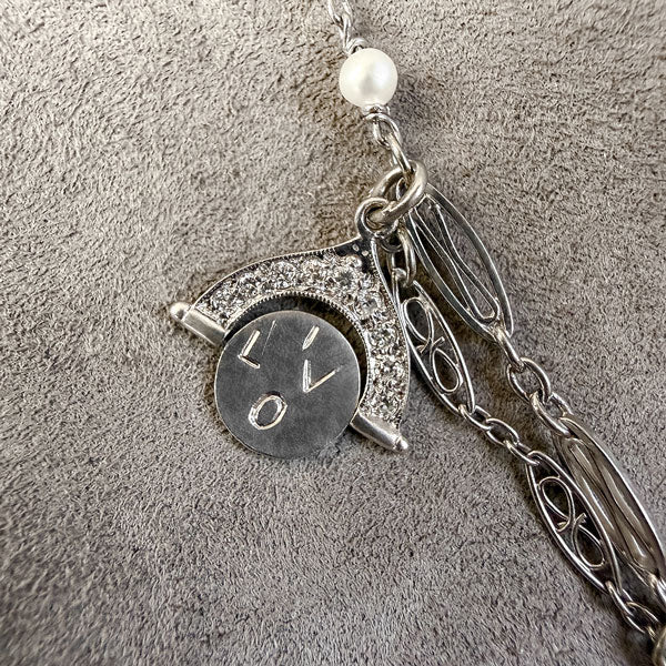 Art Deco Diamond Charm Necklace sold by Doyle and Doyle an antique and vintage jewelry boutique