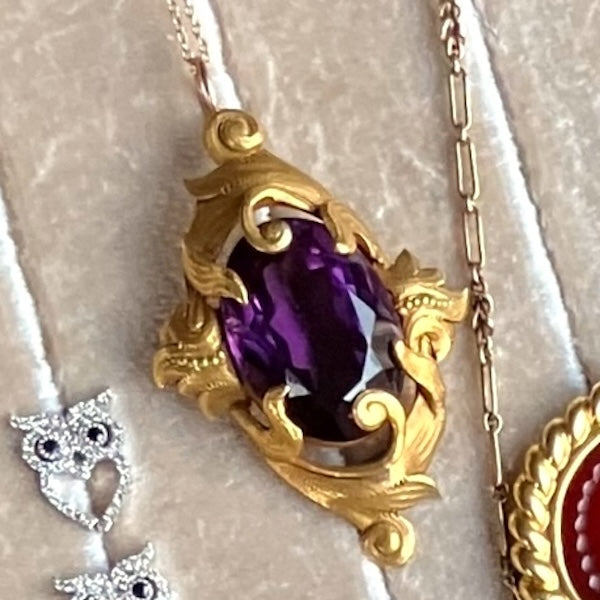 Antique Amethyst Pendant with gold scrolling frame, from Doyle & Doyle antique and vintage jewelry boutique