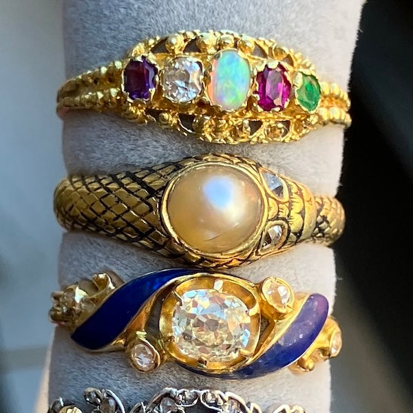 Three antique gold rings set with gemstones, diamonds, pearl, and enamel, from Doyle & Doyle antique and vintage jewelry boutique