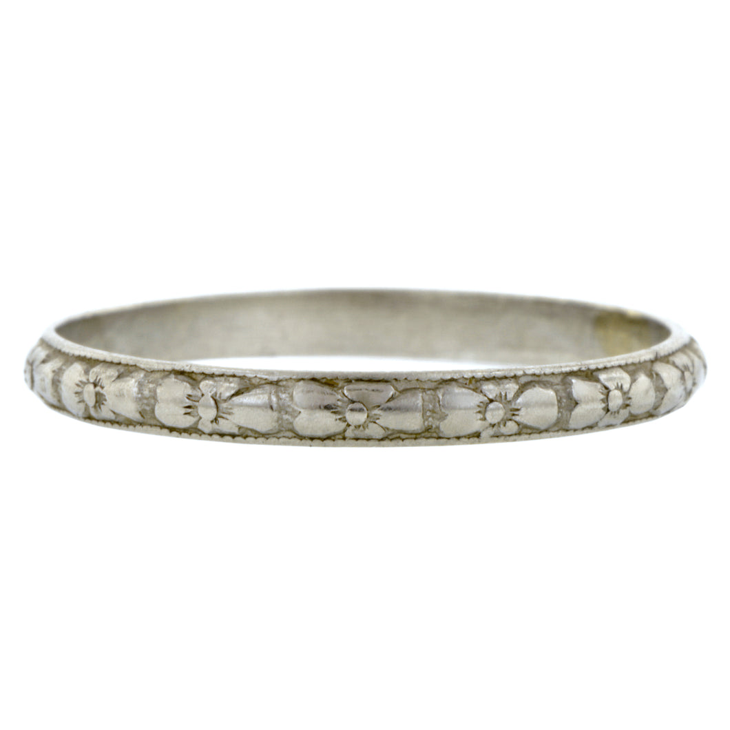 Art Deco ring; a Platinum Repeated Flower Design Pattern Wedding Band sold by Doyle & Doyle vintage and antique jewelry boutique.