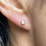 Oval Cabochon Opal Stud Earrings, sold by Doyle & Doyle an antique and estate jewelry boutique.