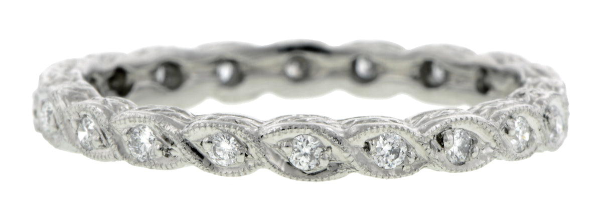Contemporary ring: a Platinum Diamond Eternity Twist Design Band sold by Doyle & Doyle vintage and antique jewelry boutique.